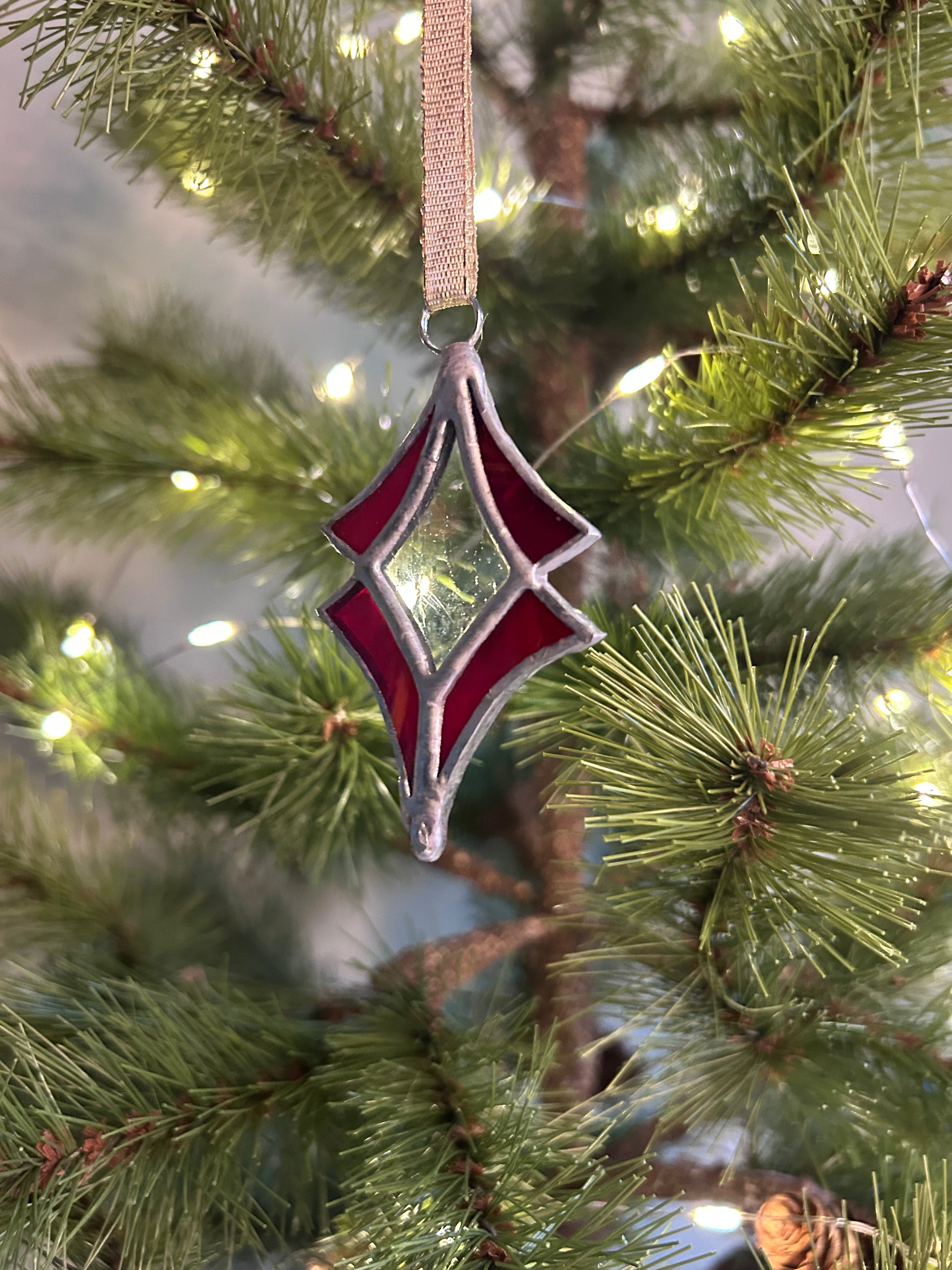 Decorative red and silver ornament on a Christmas tree